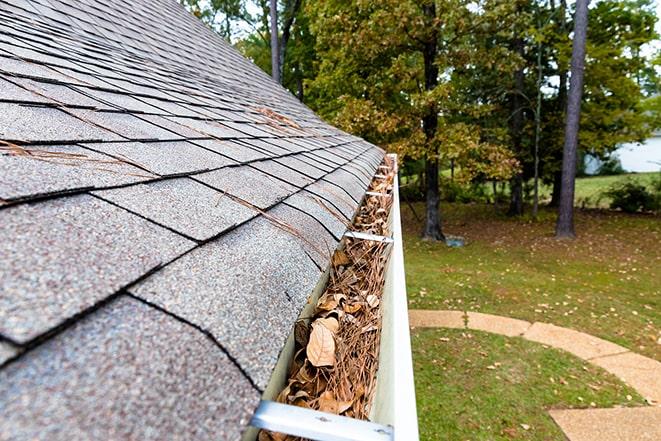 a professional gutter cleaner at work